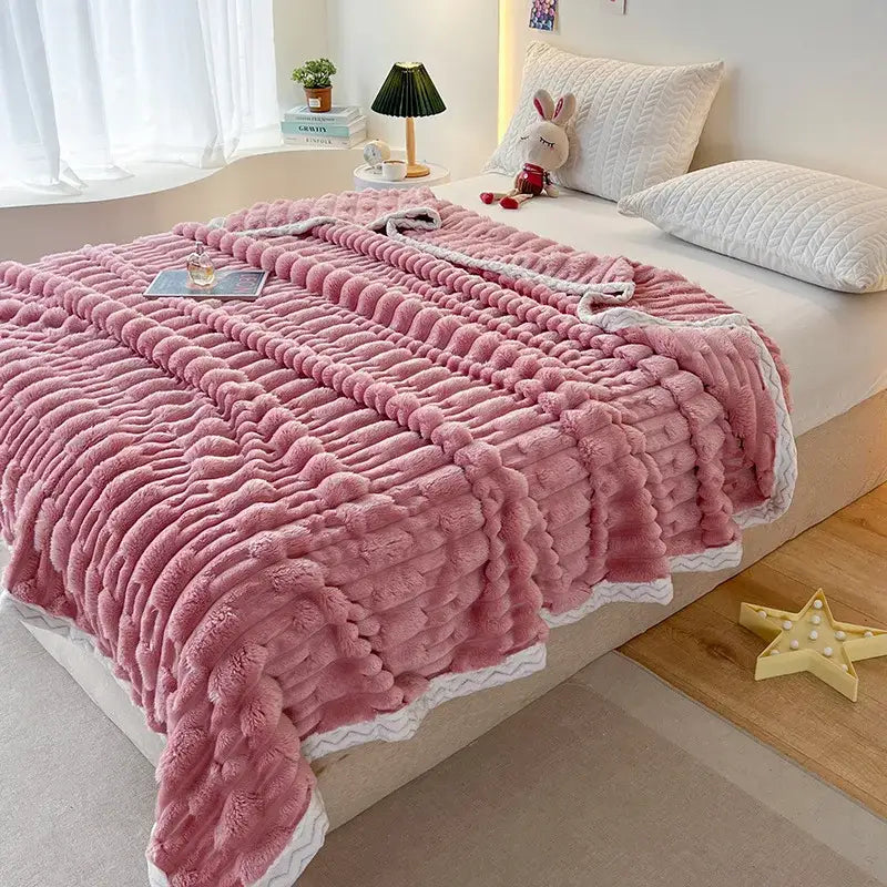 Plush pink bamboo velvet blanket with ribbed knit texture and white zigzag braided trim for bedroom throw use