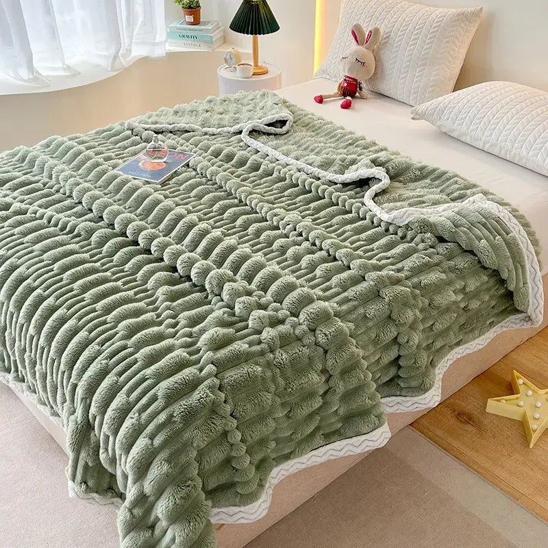 A soft moss green bamboo velvet blanket with a textured wavy pattern and white scalloped edges for bedroom use
