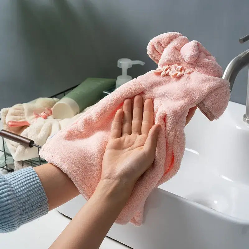 A soft pink coral fleece cheongsam hand towel with plush texture bow and ruffled edges for kitchen and bathroom decorbites