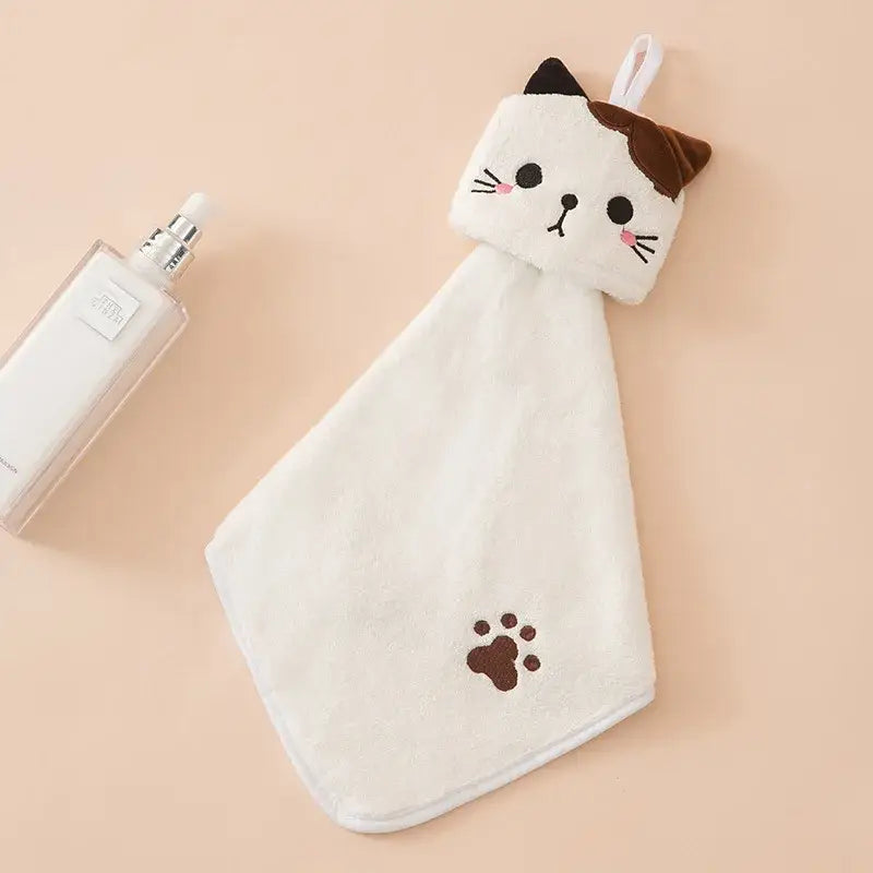 A soft white plush hand towel with a cartoon cat face design in pink and pale yellow by decorbites cartoon cat