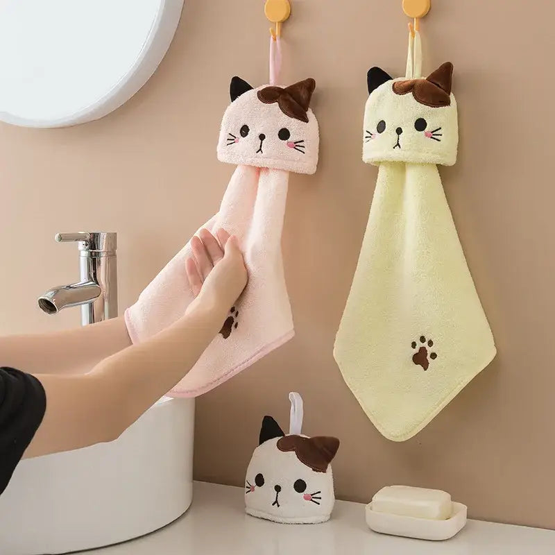 Plush pink and pale yellow cartoon cat hand towels with embroidered facial features and paw prints for kitchen use