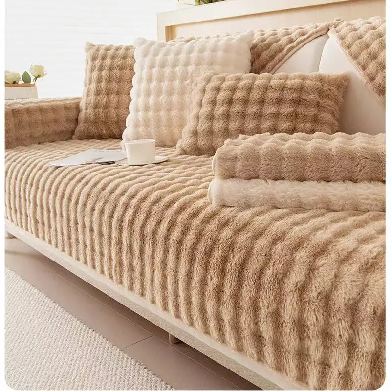 Beige plush textured sofa cover with ribbed and quilted patterns made of cream rabbit fur for living room use