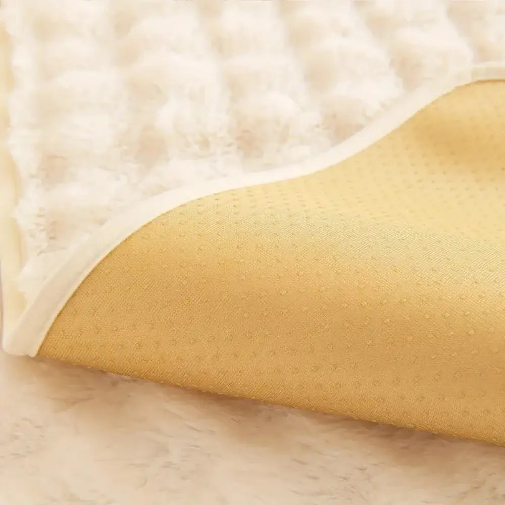 Plush quilted beige and cream rabbit fur sofa slipcover featuring a soft white top and golden yellow perforated underside