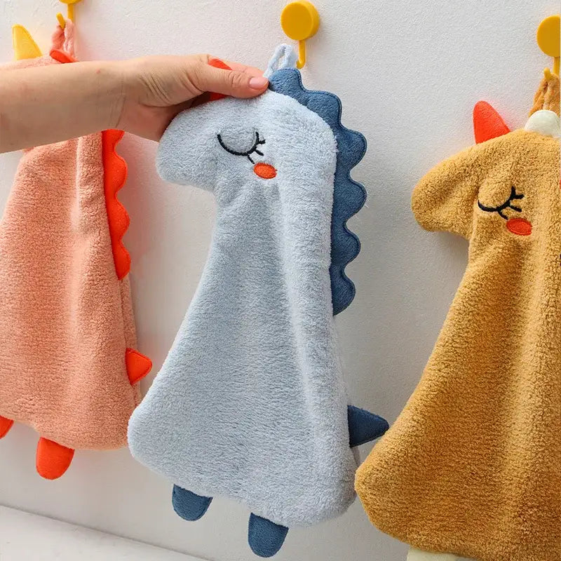 Soft light blue plush dinosaur hand towel with embroidered eyes and orange nose made of double-layer coral velvet