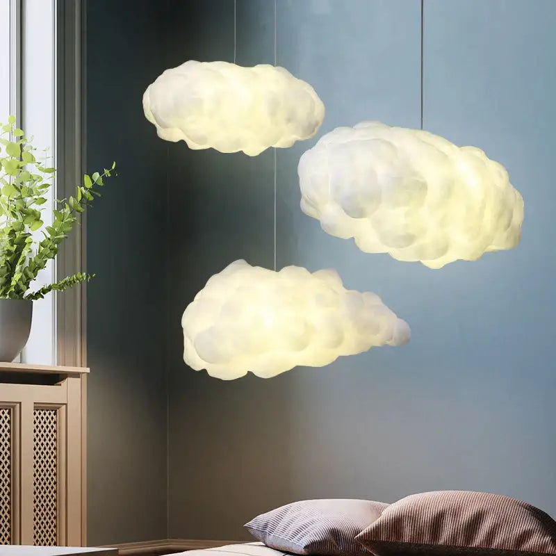 Three soft glowing white cloud led chandelier lights hanging from ceiling for nursery kids room decorbites cloud led