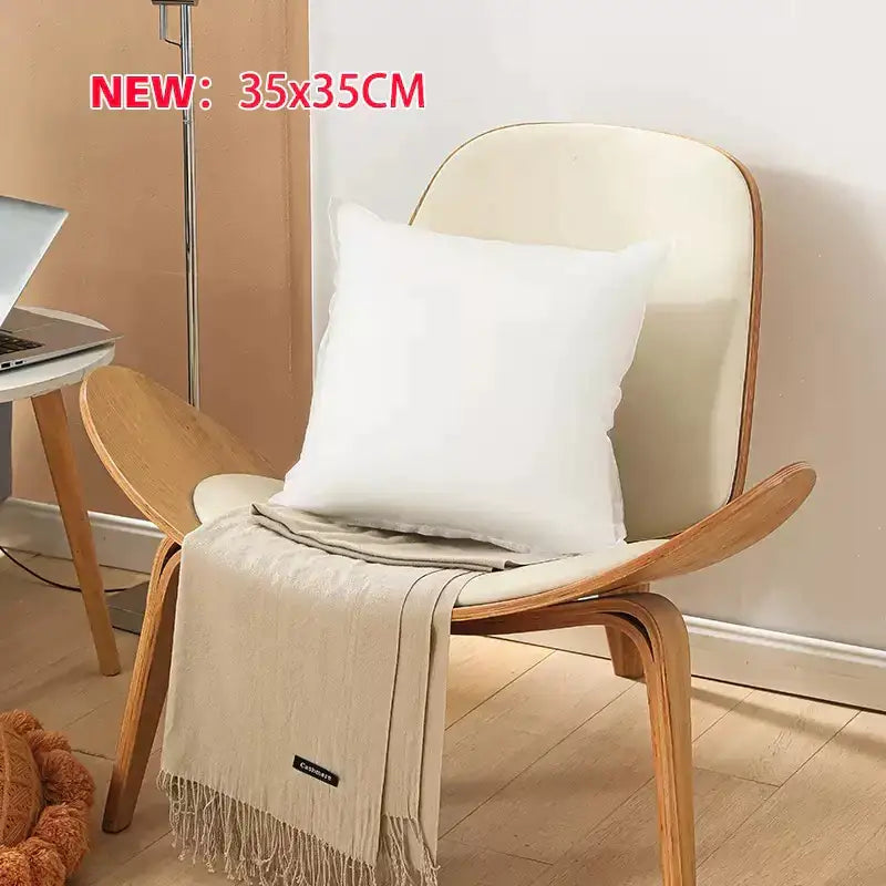 White square plush decorbites cotton-padded pillow core resting on wooden chair for living room cushion insert
