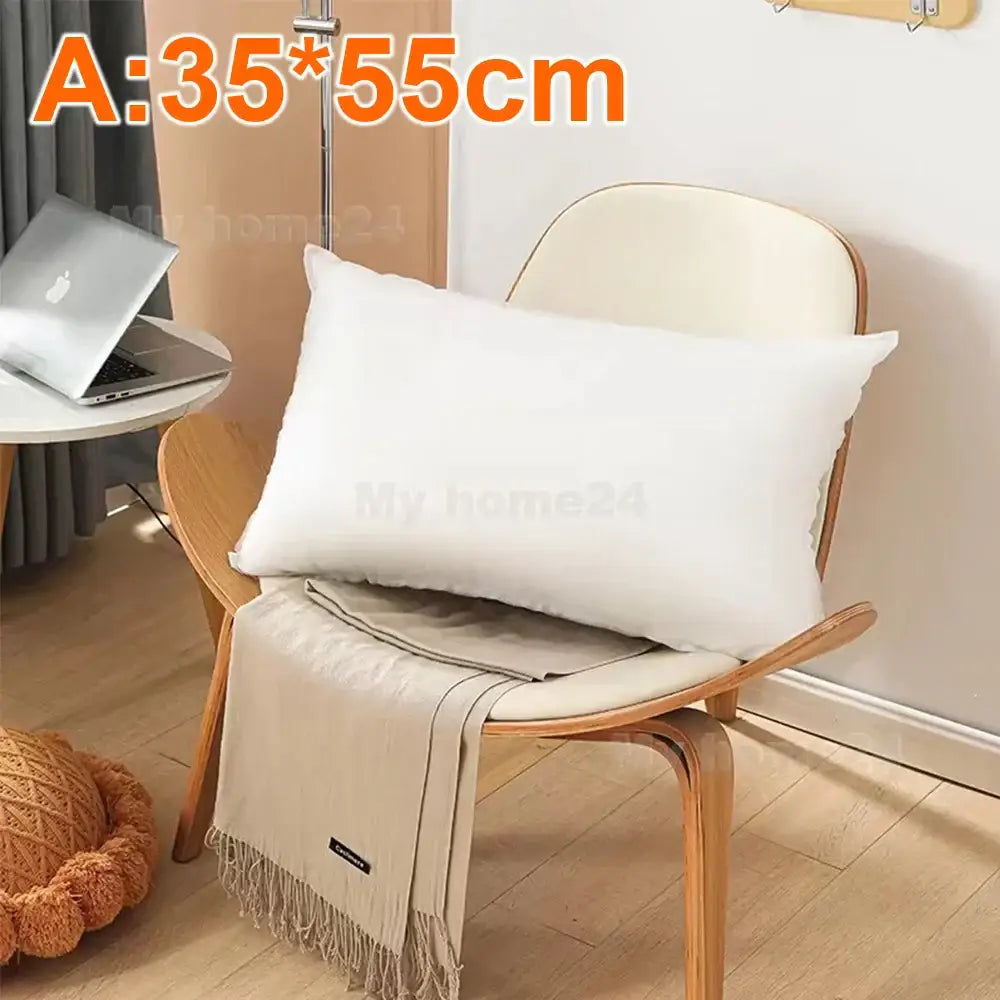 White rectangular decorbites cotton-padded pillow core with plush texture resting on wooden chair for living room decor