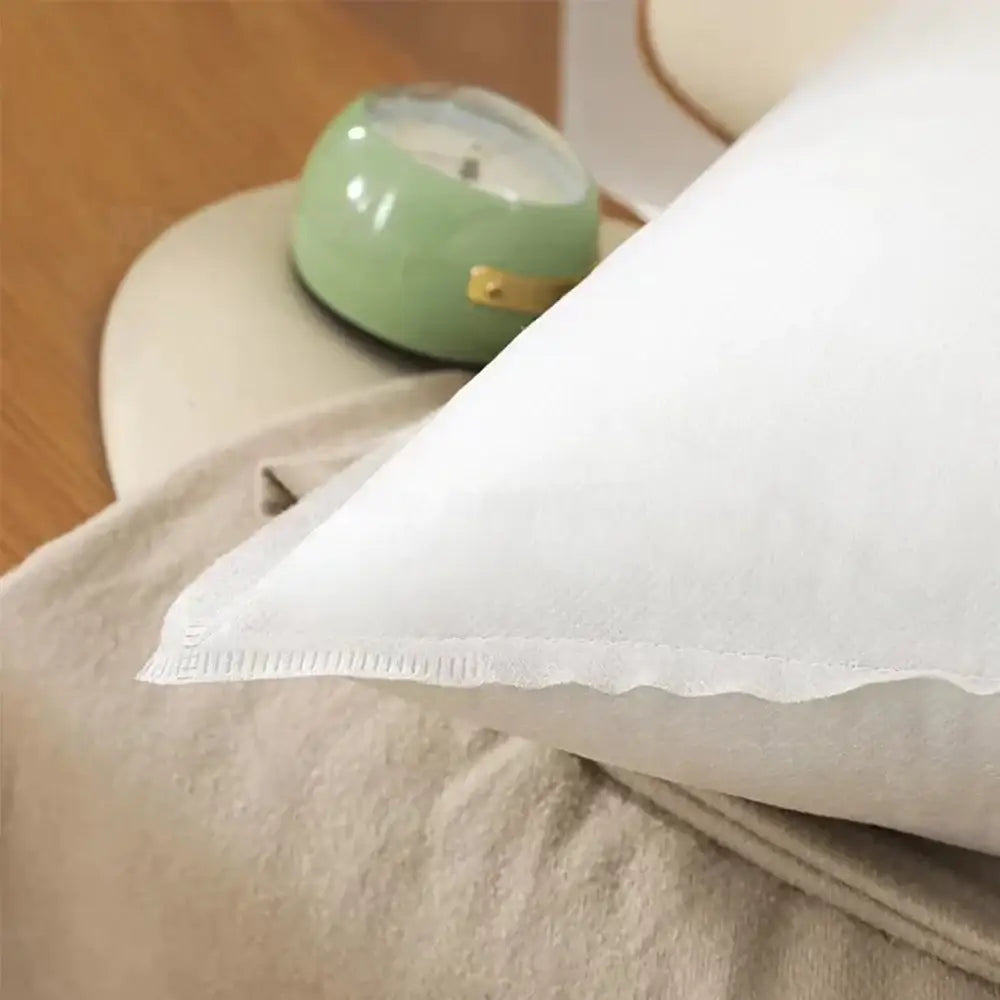Plush white decorbites cotton-padded pillow core with soft textured fabric and neatly stitched edges for living room use