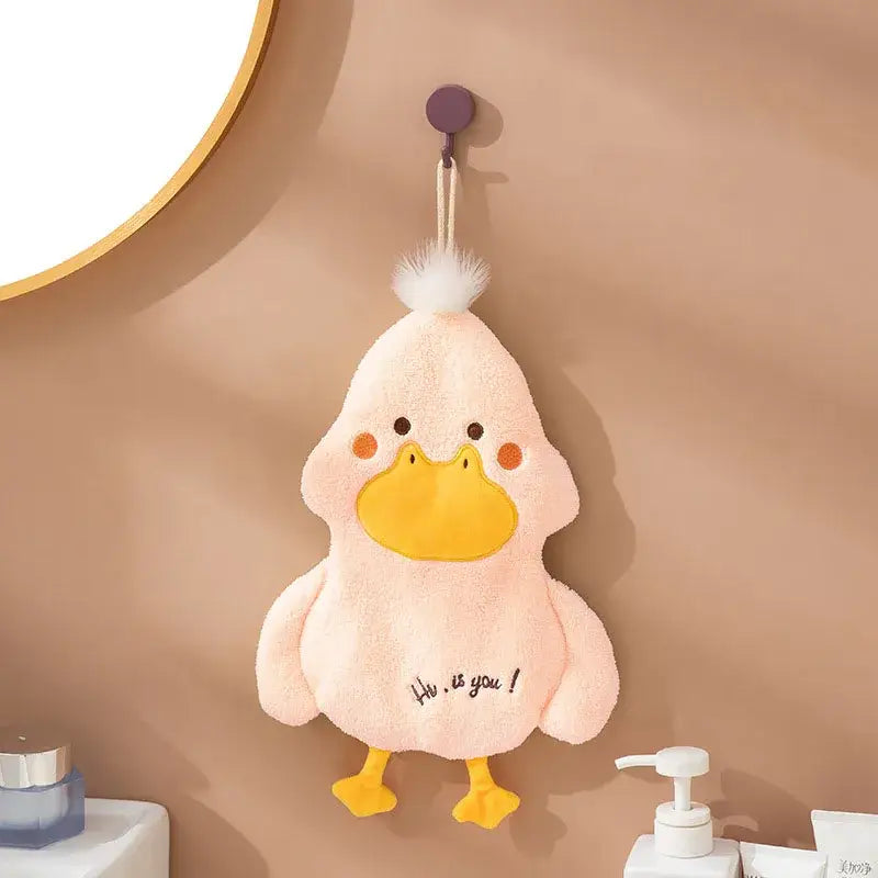 Pink plush duck terry towel holder with yellow beak and feet white tuft and hi is you stitched below for kitchen use