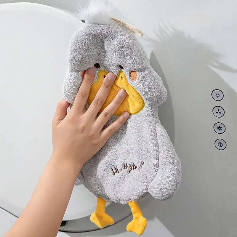 Gray plush duck terry towel with yellow beak and feet featuring embroidered text on belly for kitchen cleaning