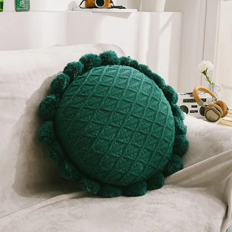 Emerald green knitted round pillow with textured diamond pattern and pom-pom trim for home decor and decorbites 3d flowers pillows