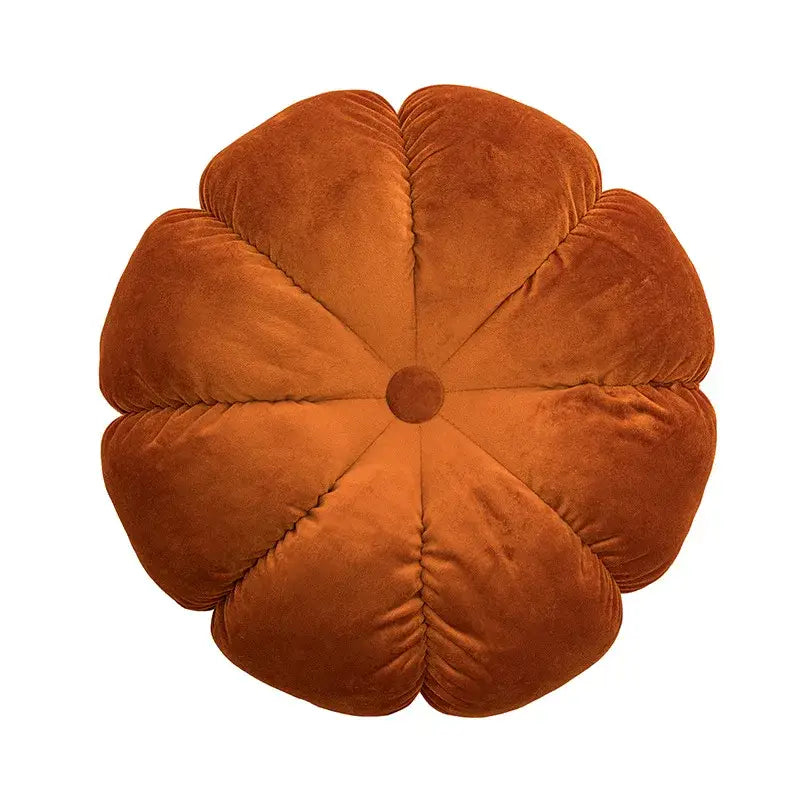 A rust-colored velvet pumpkin-shaped cushion with quilted petals and a button center for home decor and decorbites 3d flowers pillows