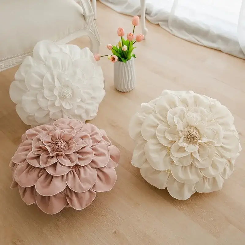 Three plush 3d flowers pillows in white and soft pink hues for home decor by decorbites