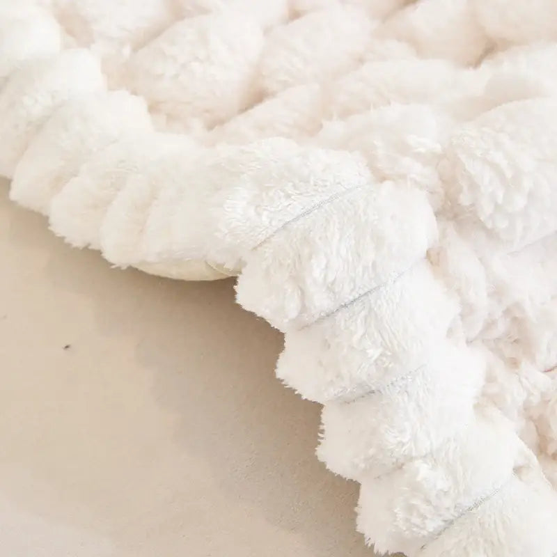 Plush white textured knitted throw blanket with soft fluffy surface for anti slip sofa cover and living room protector