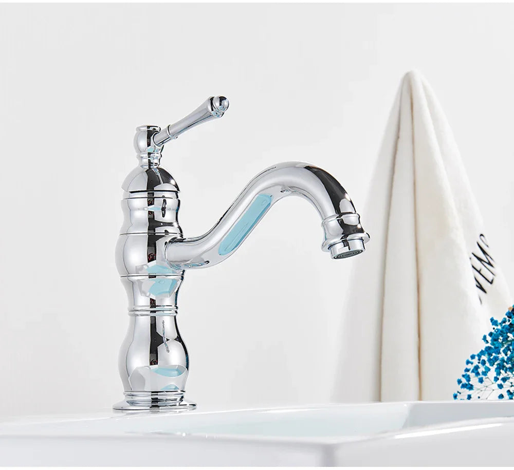 Chrome-finished deck mounted single hole vintage-style bathroom faucet with curved spout and ornate segmented housing material