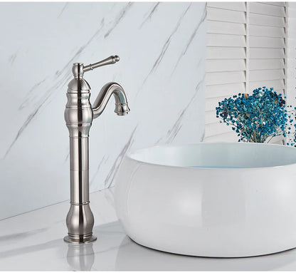 Stylish brushed nickel single hole deck mounted basin faucet with curved spout and decorative ridged base housing material
