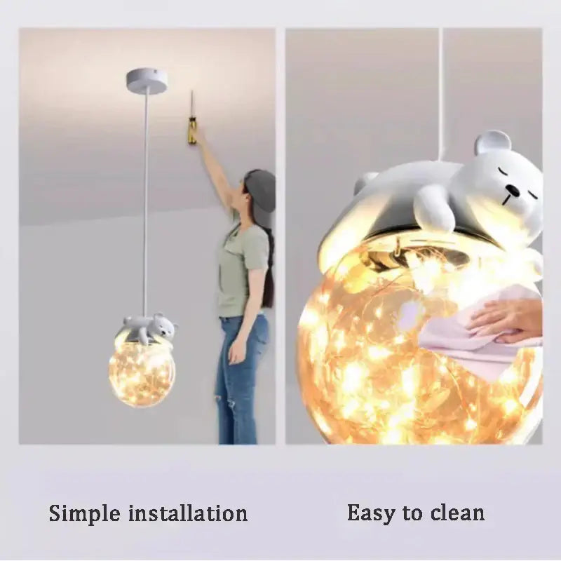 A white plush polar bear on a glass animal led chandelier pendant light with warm fairy lights for children’s room