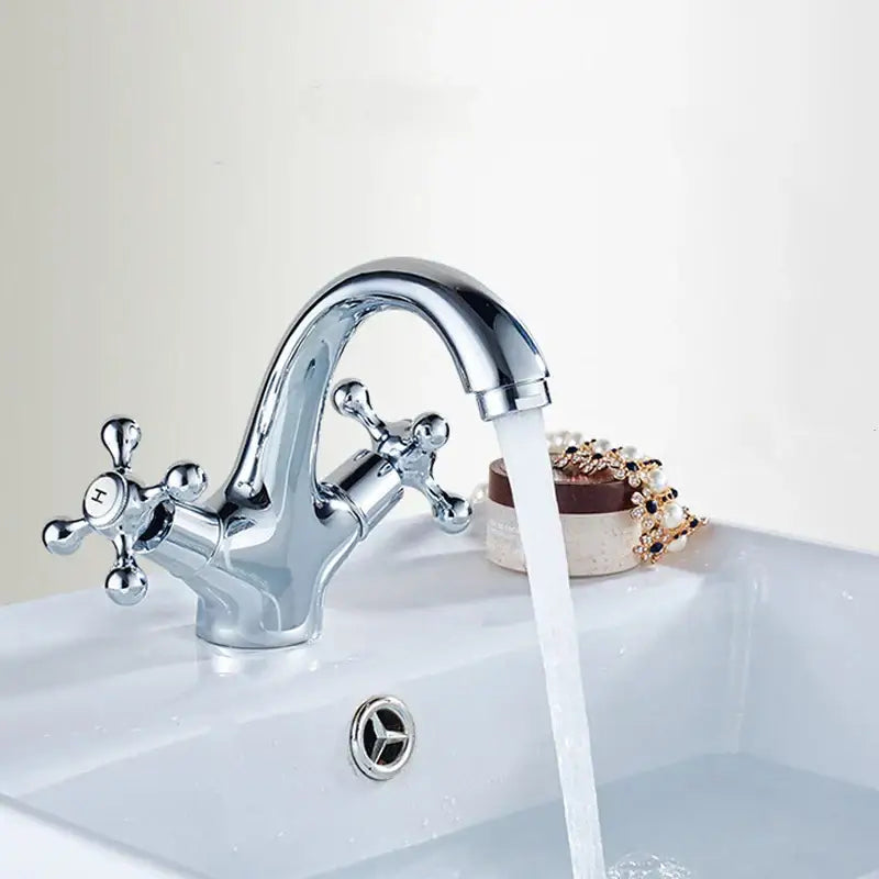 Chrome finished vintage bathroom faucet with dual cross handle controls and curved spout for bidet use