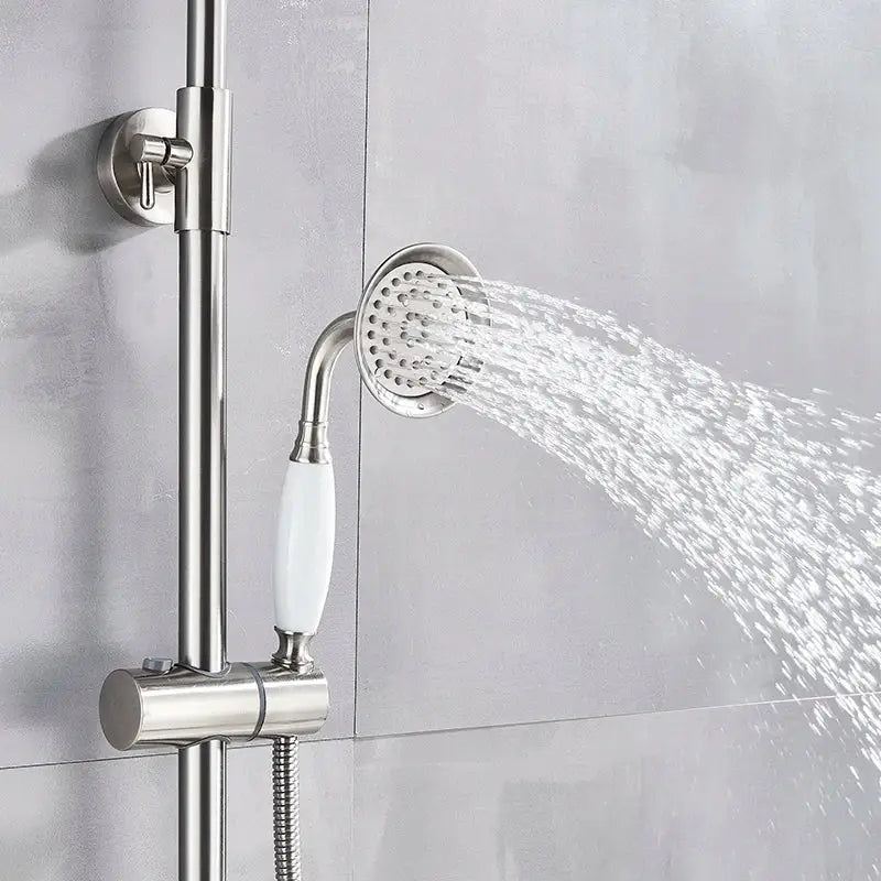 Polished chrome shower faucet set featuring a stainless steel shower head with white ceramic handle and adjustable spray pattern