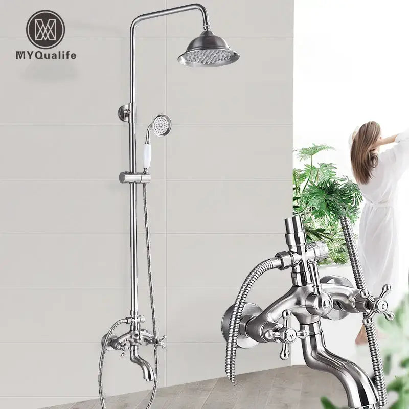 Polished chrome stainless steel shower faucet set with tall rainhead, handheld spray, and cross-handle controls for bathroom