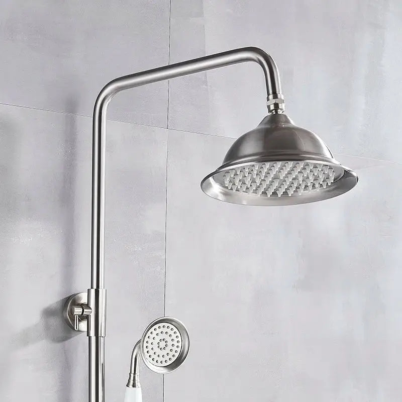 Polished chrome stainless steel shower faucet set with sleek curved arm and matching handheld sprayer for bathroom