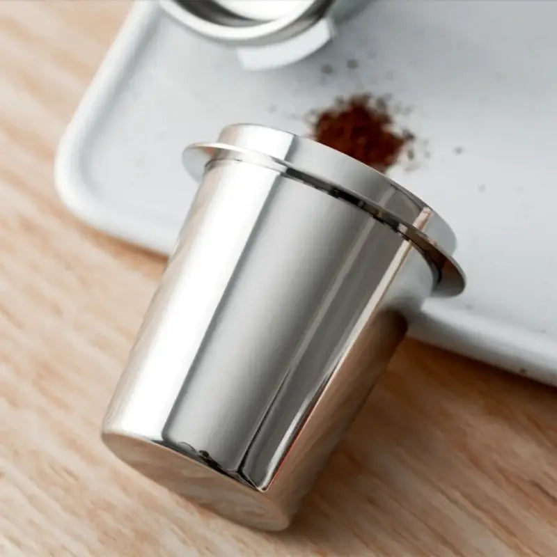 Polished chrome stainless steel espresso dosing cup with a shiny cylindrical body and slightly flared rim for dosing cup use