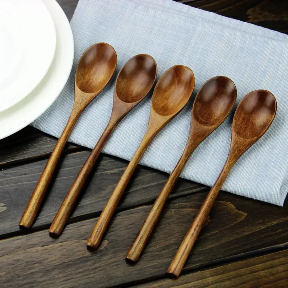 Set of five polished dark brown wooden spoons with smooth ergonomic handles for spoon soup and dining use