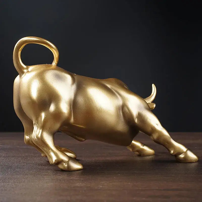 Polished gold wall street bull statue with reflective metallic finish and looped tail handle for decorbites gold wall decor