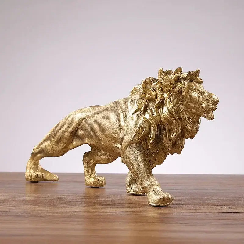 Polished golden lion king resin statue with detailed mane and textured surface on wooden table decorbites golden lion