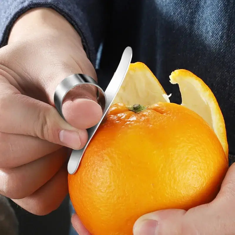 Silver finger citrus peeler with sleek curved blade and polished stainless steel finish by decorbites citrus peeler