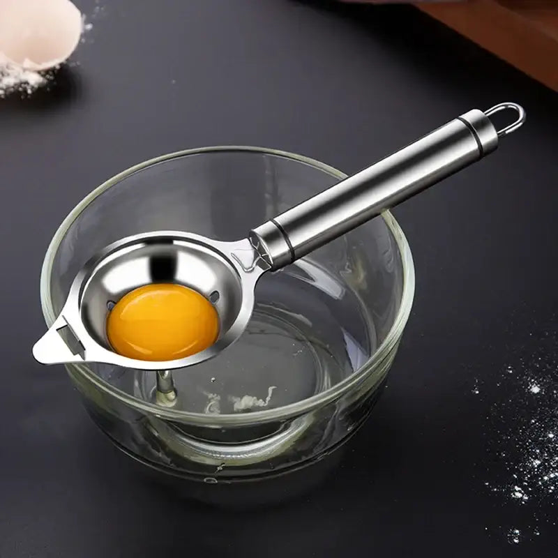 Polished stainless steel egg white separator with sleek finish and curved handle for easy grip and yolk filtering