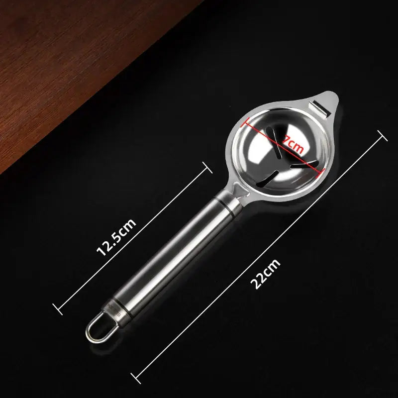 Polished stainless steel egg white separator with a shiny circular head and elongated handle for efficient white separation