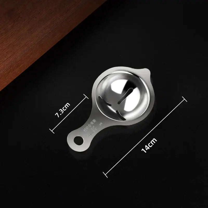 Polished stainless steel egg white separator with a sleek metallic finish and hanging hole handle for kitchen use