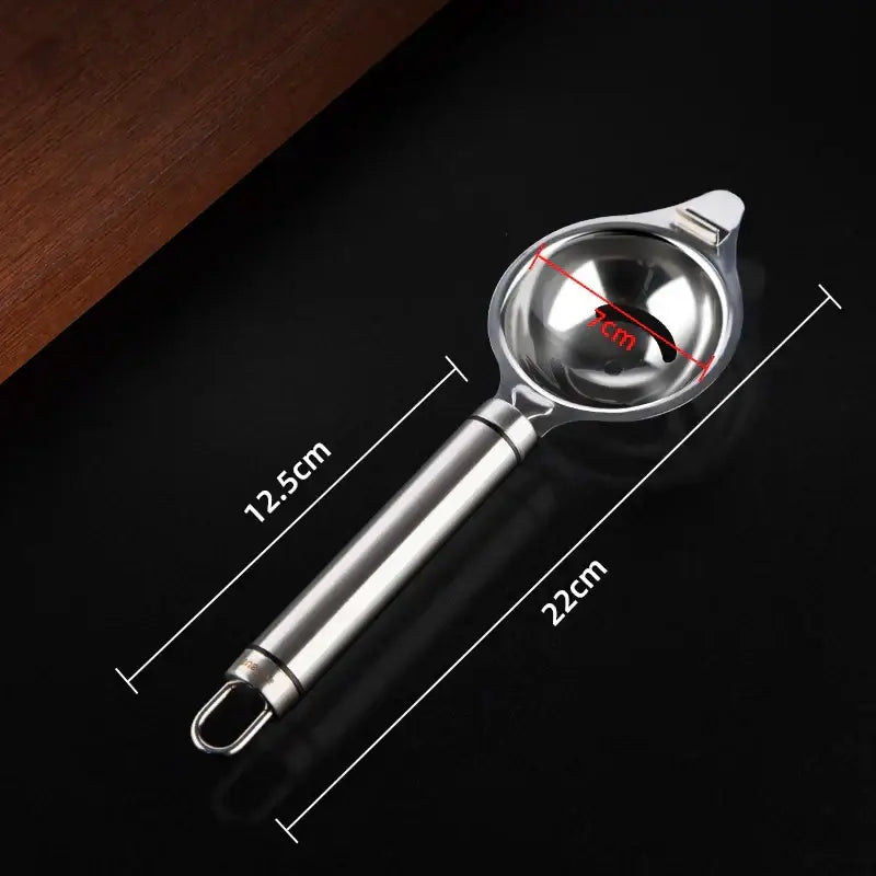 Polished stainless steel egg white separator with a sleek reflective reamer and 9cm spherical bowl for white separation