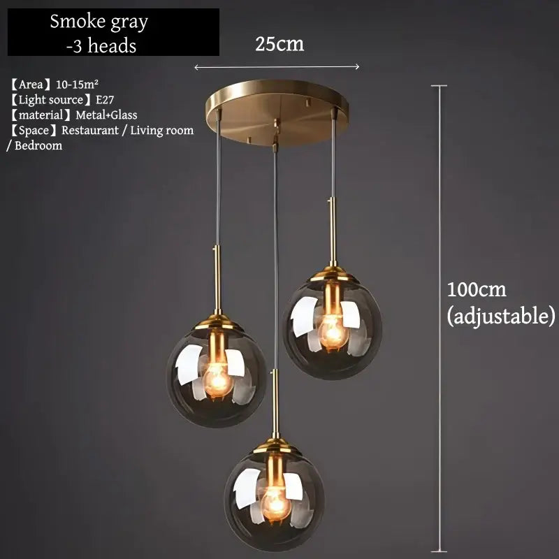 Smoke gray three-head pendant light with brass accents and glass globe shades polished steel glass pendant light for dining room