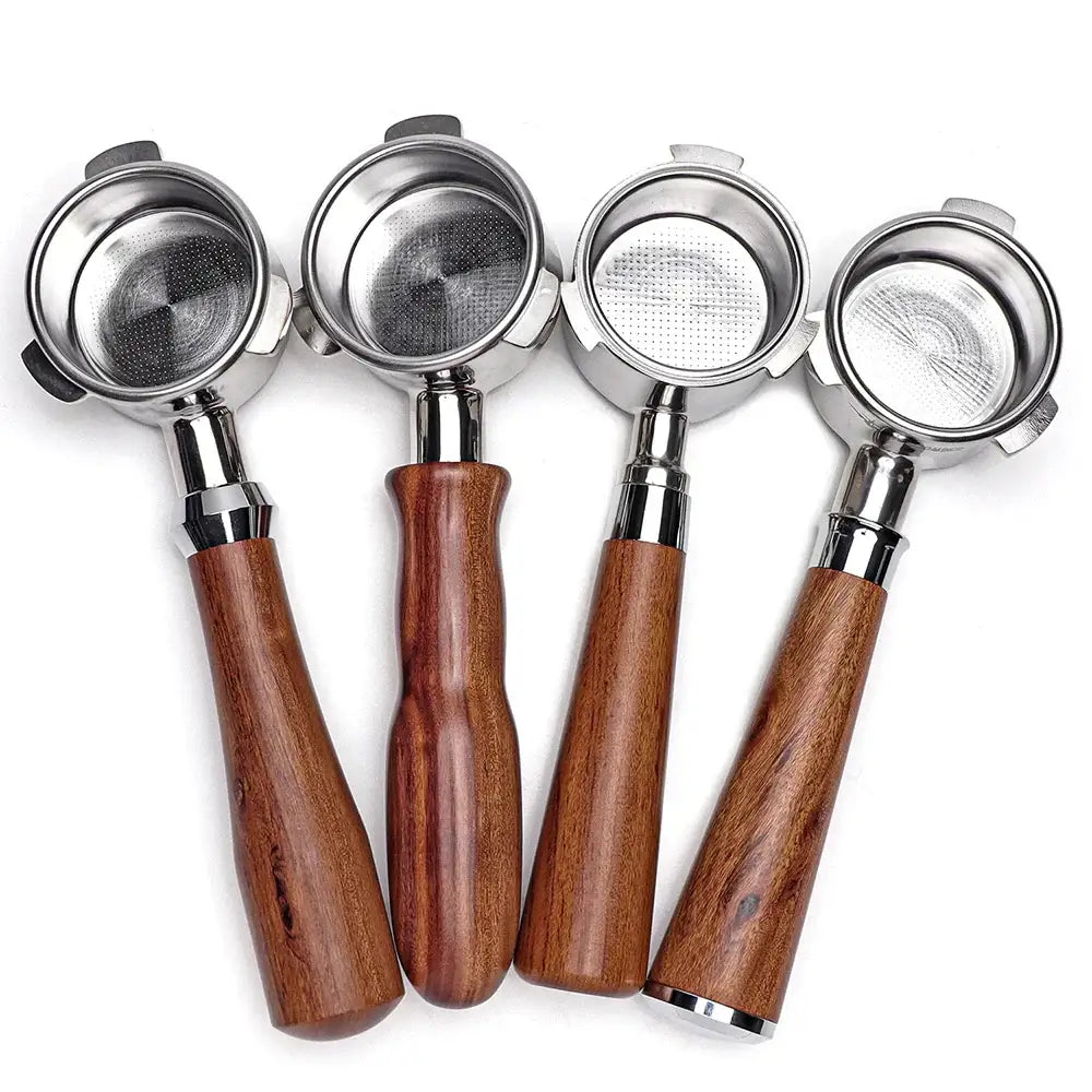 Four polished wood and stainless steel coffee bottomless portafilters with textured metal filter baskets for espresso brewing