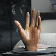 A polished wooden hand palm sculpture with natural wood grain finish for elegant living room decor
