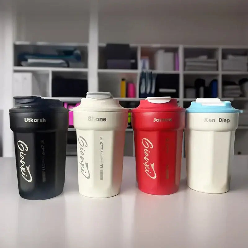 Four colorful givaudan branded 400ml coffee thermos bottles in black cream red and light blue with names on lids