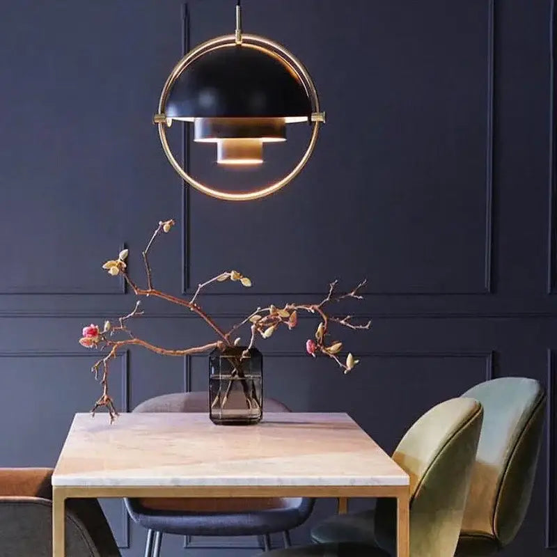 Post modern black and gold iron pendant light with sleek design hanging above dining table by decorbites iron pendant lights