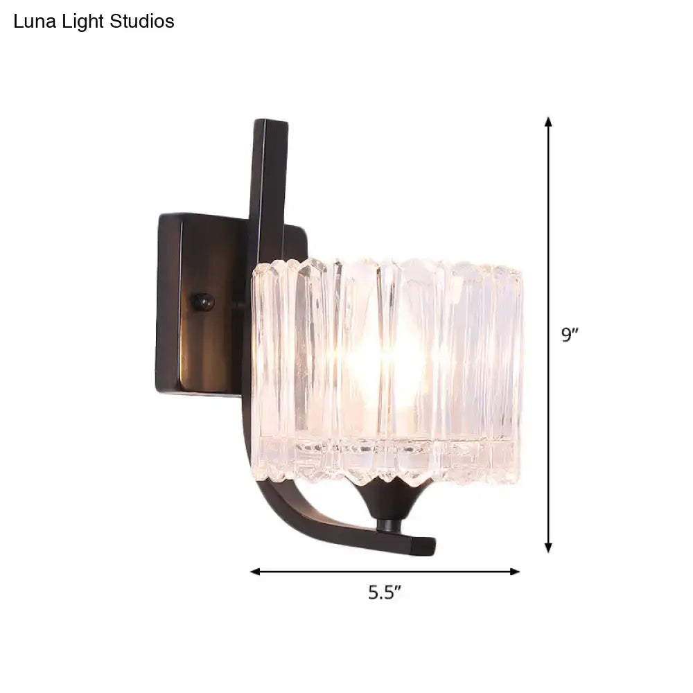 Post-modern black metal wall sconce with clear crystal shade and dark bronze frame for bedroom lighting
