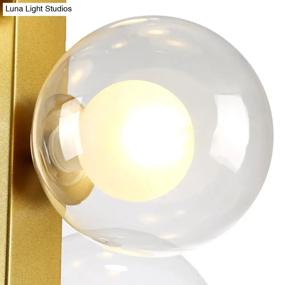 Decorbites gold finish chandelier with translucent glass orb shade and glowing light bulbs for post modern dining room