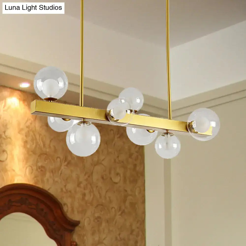 Decorbites gold finish chandelier with clear glass globe light bulbs in post modern design for dining room lighting