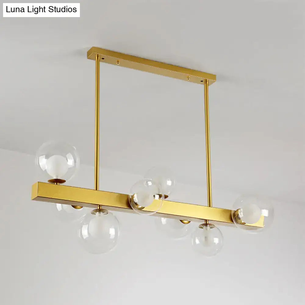 DecorBites gold finish chandelier with orb glass shades and post modern design featuring 8 light bulbs for dining room