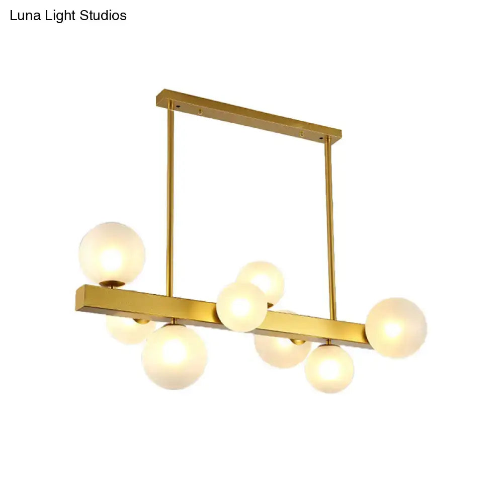 Gold finish DecorBites chandelier with rectangular frame and frosted glass globe light bulbs for dining room post modern design