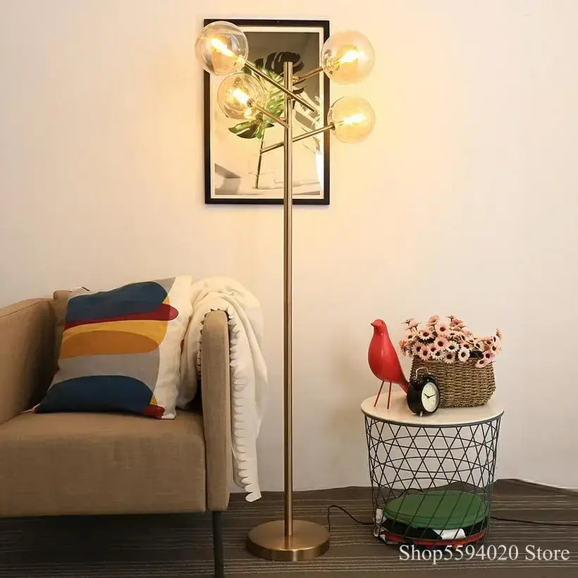 Brass-finished floor lamp with five glass bubble ball bulbs in a branching design for living room decorbites glass bubble