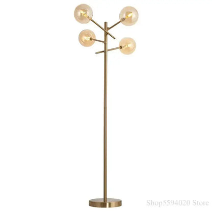 Modern brass-finished floor lamp with five glass bubble ball bulbs in a decorbites glass bubble design for living room