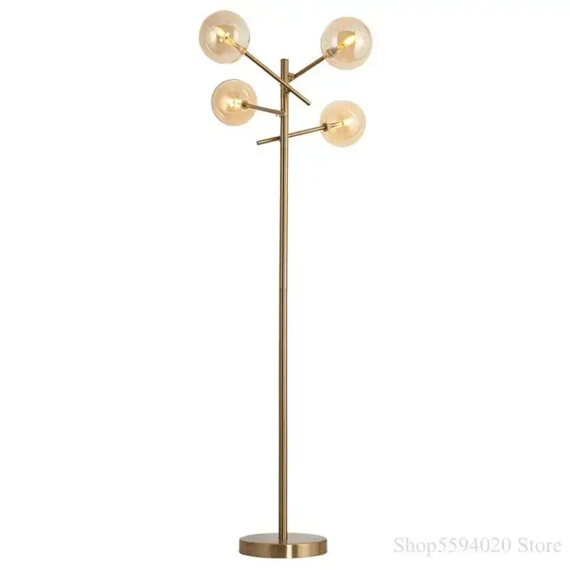 Modern brass-finished floor lamp with five glass bubble ball bulbs in a decorbites glass bubble design for living room