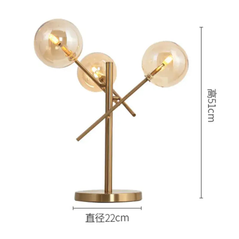 Modern brass floor lamp with three amber glass bubble ball shades in a branching decorbites glass bubble design