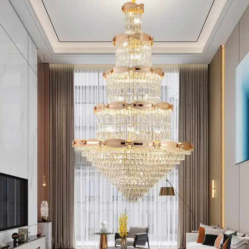A multi-tiered grand hall crystal chandelier with gold-toned accents hanging elegantly in decorbites grand hall decor