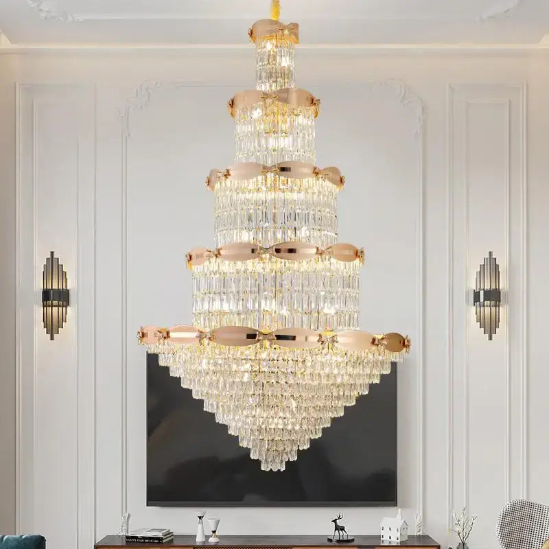 A post-modern gold grand hall crystal chandelier with rose gold accents and cascading clear crystals by decorbites grand hall